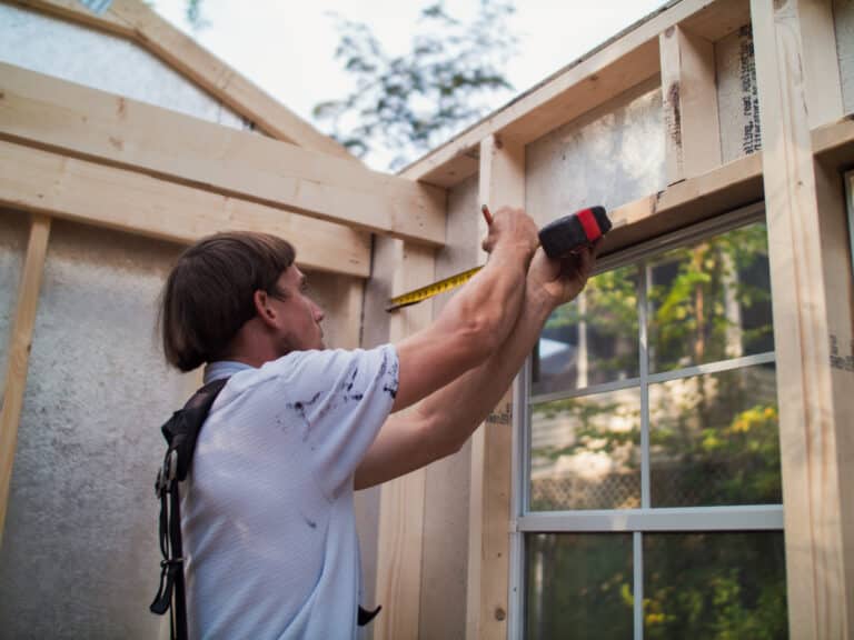 Worker measuring wood