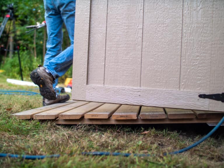 Person walking up ramp of shed
