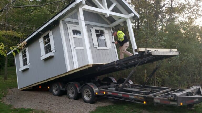 Shed being loaded onto truck
